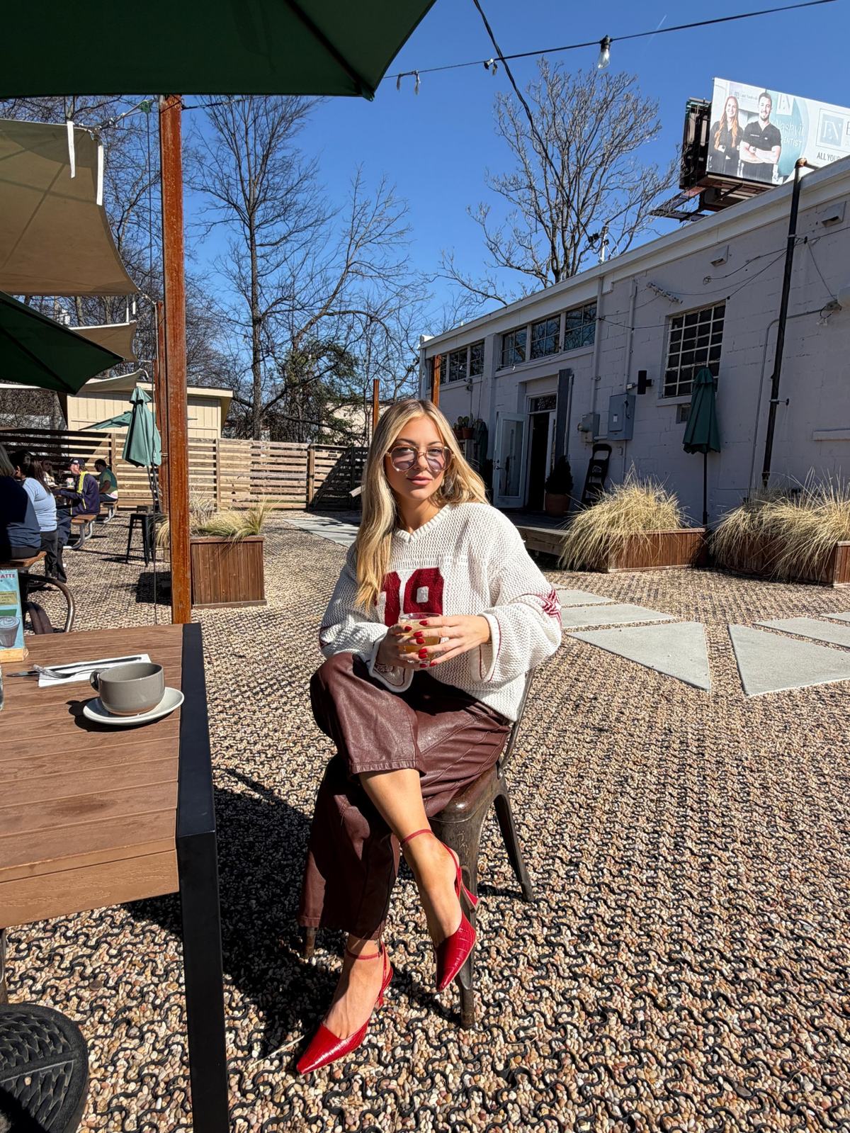 Alivia at a Nashville coffee shop patio on a sunny day